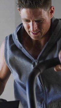 Vertical video: Man reaching handle, logging fitness on screen while code dots overlaying, clearing