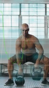 Vertical video: Man in gym driving through legs pulling KBs for power as finance charts overlaying