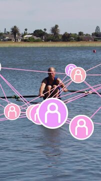 Vertical video: Male rower rowing and placing blades, causing pink overlay around boat for sports