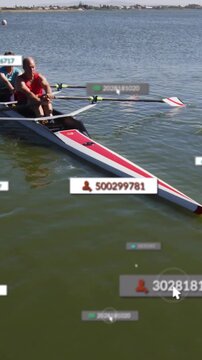 Vertical video: Man and woman rowing oars splashing making wake as cursor clicking sports overlays
