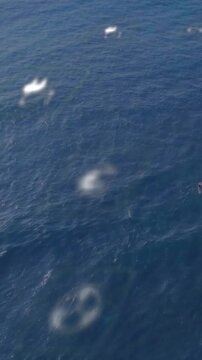Vertical video: Camera shifting down revealing AR overlay anchored on sea, monitoring power nodes