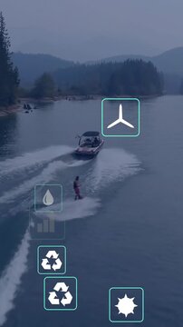 Vertical video: Pilot towing rider, wakes spreading, teal icons over showing eco metrics for sport
