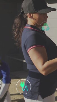 Vertical video: Coach gesturing briefing baseball team as green plug or recycle icons overlaying ben