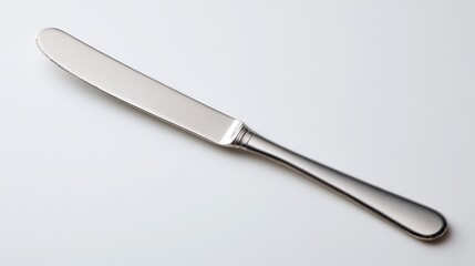 Fototapeta premium Minimalist butter knife on a clean white surface, polished blade and satin handle