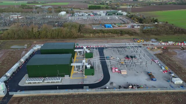 High-altitude aerial shot of the Walpole Substation complex, highlighting the integration of synchronous condensers with existing 400kV transmission lines.