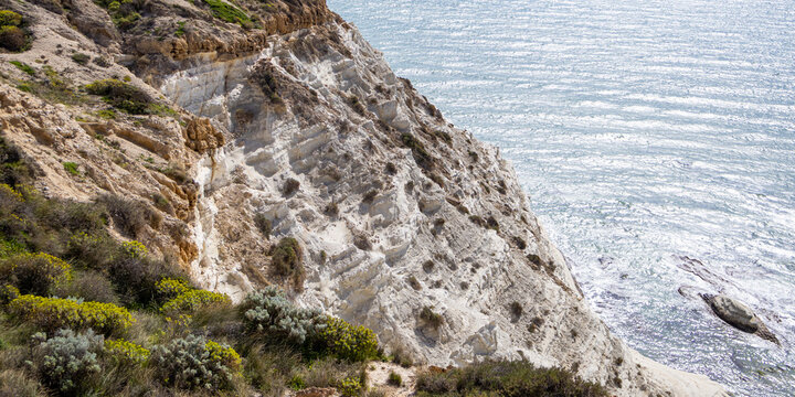 Panoramic view of white sandstone cliff of Scala dei Turchi, shaped like a giant staircase and named after the Turk pirates used to hide in this cove, Sicily, Italy