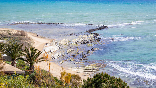 Panoramic view of white limestone cliffs and turquoise Mediterranean sea at Scala dei Turchi in Sicily under clear sky. Iconic coastal landscape symbolizing travel, nature beauty, summer vacation and 