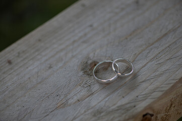 Two Wedding Rings on Wooden Surface