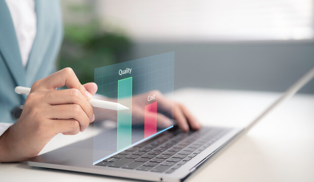 Businesswoman using stylus on laptop analyzing quality and cost chart with digital interface showing business analysis strategy data evaluation performance management and decision making