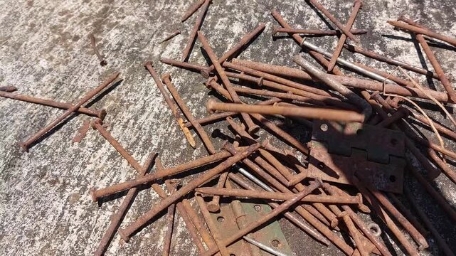 footage of many old rusty nails showing corrosion and decay caused by the oxidation process. 
