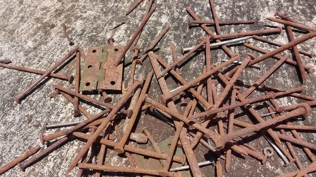 footage of many old rusty nails showing corrosion and decay caused by the oxidation process. 