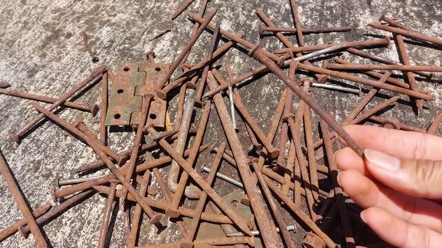 footage of many old rusty nails showing corrosion and decay caused by the oxidation process. 