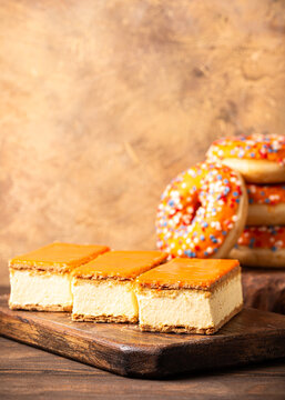 Glazed orange tompouce and donuts dessert with Dutch event Kings day in background. National holiday Koningsdag on 27 April in the Netherlands. Holland culture concept with copy space