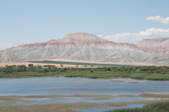 Scenic landscape with clay mountains and a serene lake