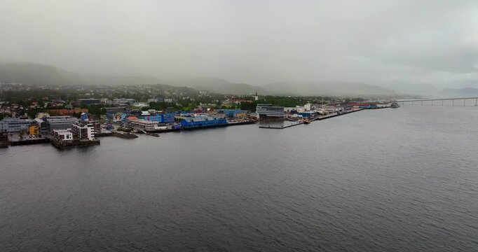 Aerial establishing of Sortland harbor and waterfront in Vesteralen Norway under misty sky