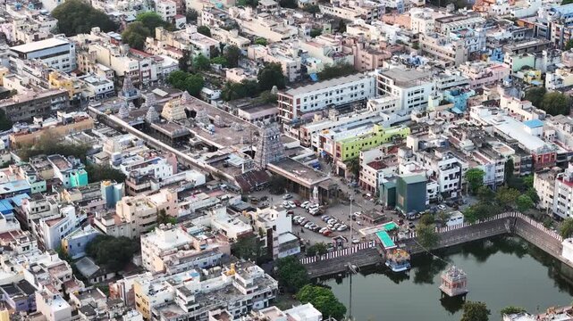 Aerial perspective of Triplicane, Chennai, highlighting the iconic Parthasarathy Temple tank at the center, enclosed by traditional neighborhoods, temples, and bustling city blocks near Marina Beach.