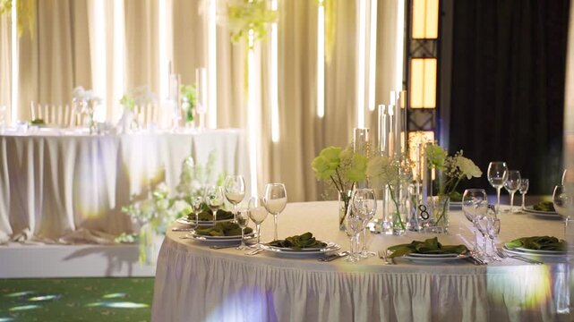 Stylish table decor. Sophisticated wedding table arrangements. Classy floral accents and candlelit centerpieces. Refined glassware complemented by elegant flower arrangements for festivities