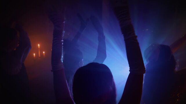 blue orange neon light, people hang out dancing crowd hands arms raised up waving to sides in dark black night club. female male have fun at dance floor, roaring twenties 1920s retro party old style