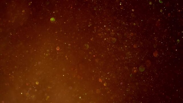 An animation loop of blue snowflake particles in motion across a dark starry galaxy background creates an abstract winter design for a Christmas holiday celebration or New Year space theme