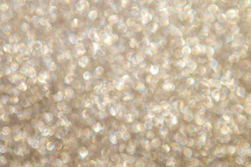 Soft golden bokeh background with sparkling glitter lights and warm abstract shimmer for design © Nataliia