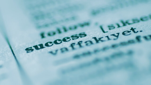 Macro photography of the word "success" and its definition in a dictionary, concept for achievement, motivation, and career growth