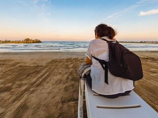 Woman traveler watching sunset on Black Sea beach in Saturn resort Romania © Dan Badiu
