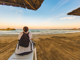 Woman traveler watching sunset on Black Sea beach in Saturn resort Romania © Dan Badiu