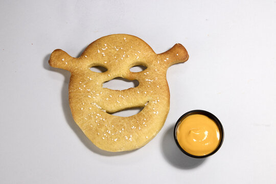 Shrek Face Shaped Bagel with Mustard Dip food