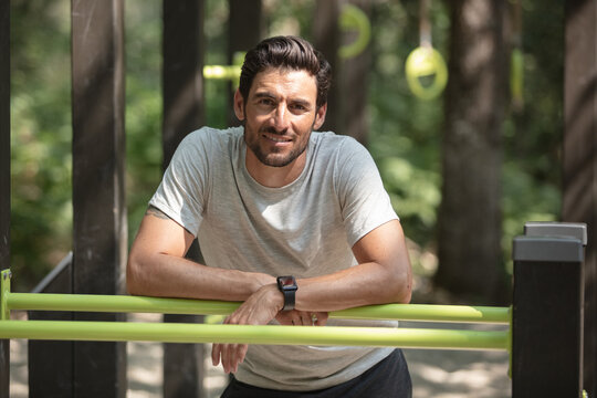 portrait young bearded man standing on public sports ground