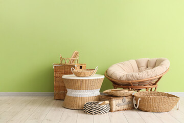 Fototapeta premium Interior of stylish living room with rattan chair, coffee table and different wicker baskets