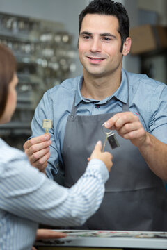 key maker giving keys to customer