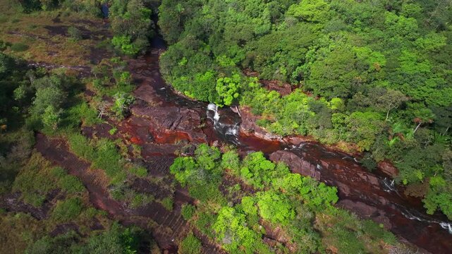 Aerial drone clip of Ca&ntilde;o Sabana captures vivid river colors, dense rainforest, and the scenic wilderness of Guaviare in southeastern Colombia.