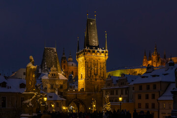 Charles Bridge Lesser Town Bridge Tower illuminating snowy night
