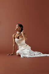 Captivating charm of a young bride in a white gown radiating elegance in a studio setting