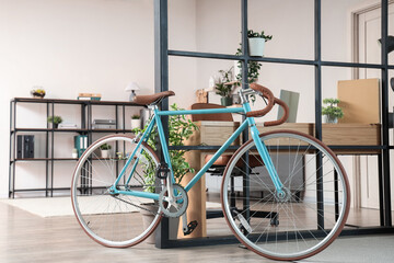 Fototapeta premium Interior of home office with bicycle, workplace and folding screen