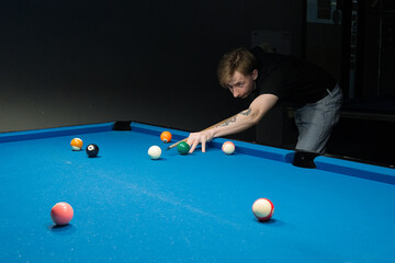 Fototapeta premium Player's hand aiming pool balls 