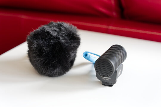 Close-up of two new Sennheiser MKE 200 microphones one with wind shield against white background. Photo taken October 12th, 2026, Zurich, Switzerland.