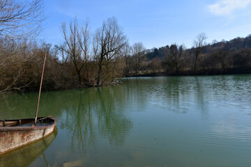 old iron cargo barge at a shore lake in Germany