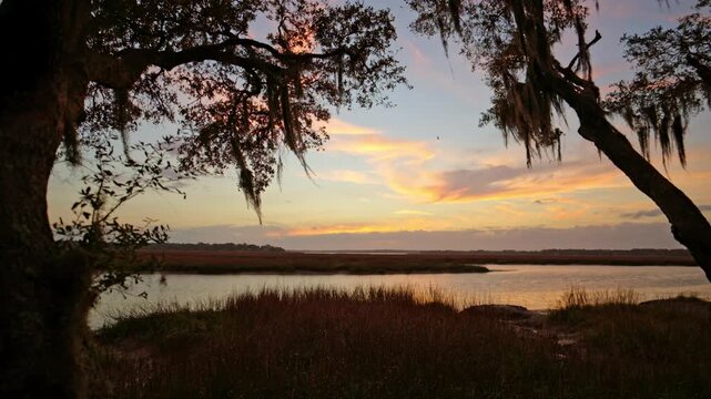 Sunset over the marsh at low tide in South Carolina near the coast in the early evening of spring