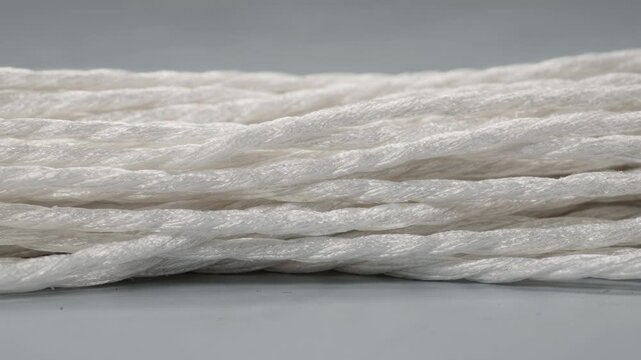 Medium shot focusing on adhesiveready polyester industrial yarn highlighting its surface treatment designed for superior bonding in rope manufacturing.