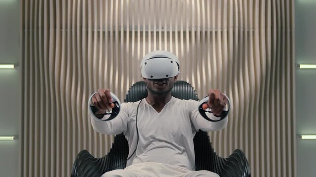 African American man in virtual reality playing game in futuristic space raising hands arms moving holding controllers male guy play VR game using cyber innovation futurism device technology helmet