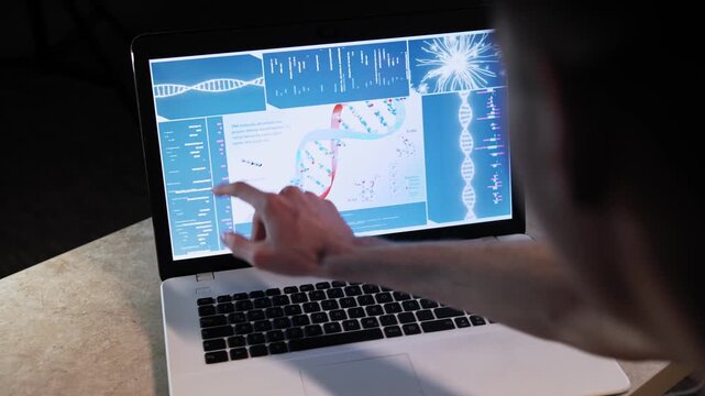 Man on laptop display explains diagram of a DNA molecule with its parameters