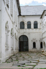 Fototapeta premium Courtyard with buildings of a medieval monastery of the 17th century in the Kremlin in Rostov the Great