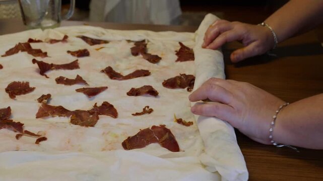 Rolling Thin Dough Filled with Pastirma Slices for Savory Pastry
