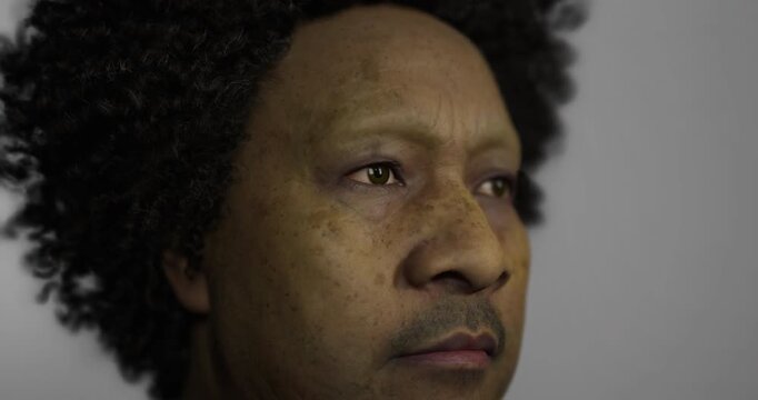 A lifelike mannequin displays curly dark hair and pronounced facial features, including freckles. The mannequin is set against a plain neutral backdrop enhancing its detail.