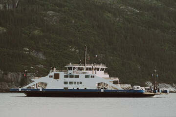 This image depicts a majestic ferry anchored on tranquil waters during sunset, embodying the beauty of twilight and serene maritime experience.
