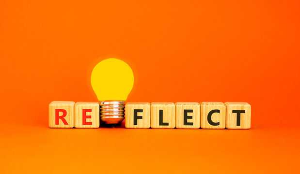 Reflect word symbol. Concept word Reflect on beautiful wooden blocks. Beautiful orange background. Beautiful yellow light bulb. Business psychological reflect word concept. Copy space.