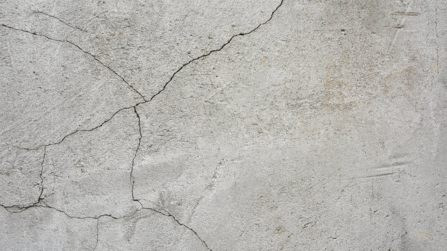 old plaster on the wall, cement, adhesive for screed. the old clay wall is crumbling. surface wall for vintage background. Wall texture, cracked plaster, grey cement floor, needs repair, restoration