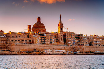 Fototapeta premium Church Our Lady of Mount Carmel, Dome of St. Paul's Cathedral in Valletta at sunrise, Malta.