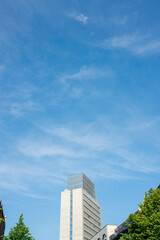 Fototapeta premium Modern City Skyscraper Building Against Blue Sky Urban Architecture